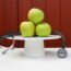 vegan health benefits three green apples on a pedestal with a stethoscope