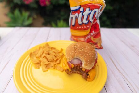 vegan junk food including a bag of Fritos and a Beyond Burger with Follow Your Heart cheese