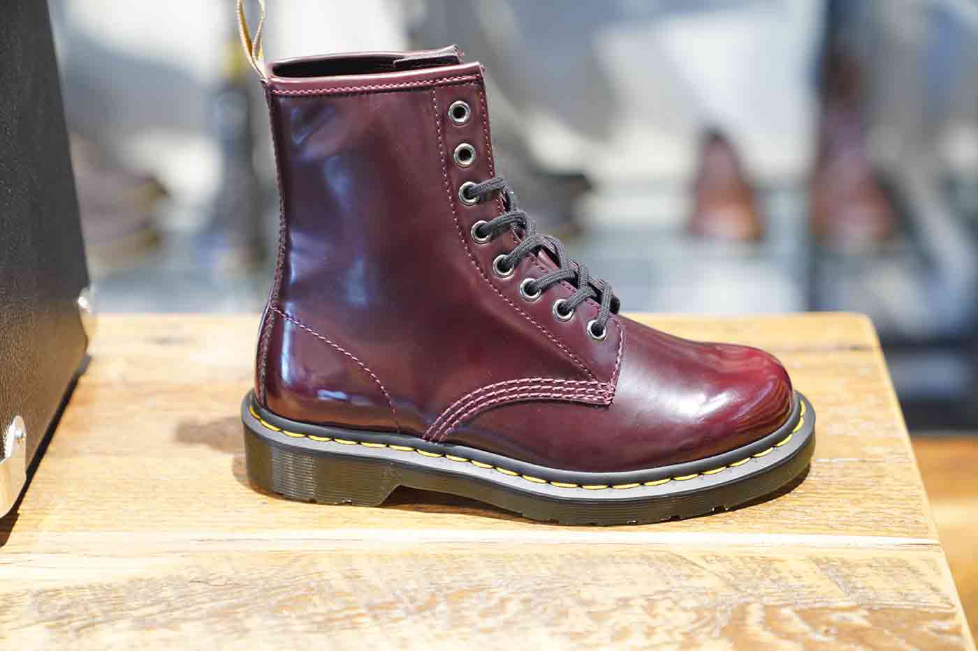Dr. Martens 1460 vegan eight eye boots cherry red oxford rub off displayed at a company store in Los Angeles