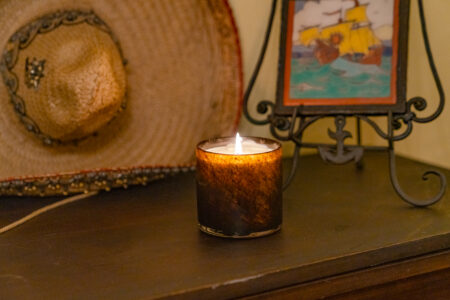 Redwood LAFCO candle pictured with a vintage Mexican hat and Spanish tile