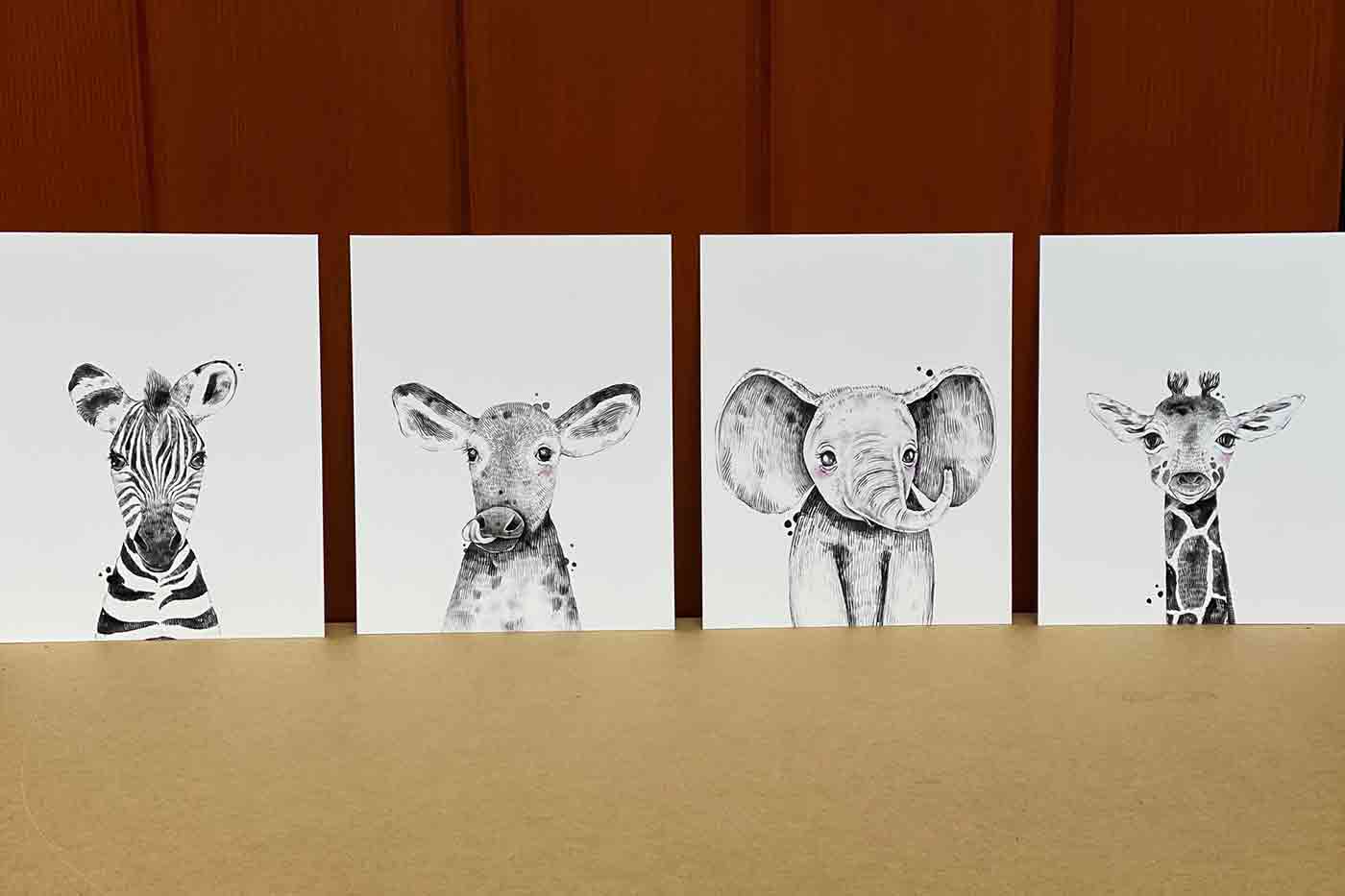 baby animal artwork for a nursery including a baby zebra a baby cow a baby elephant and a baby giraffe