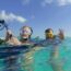 two scuba divers with cameras ready to descend Bonaire Island