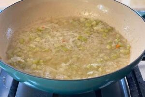 diced onion and celery cooking in vegan butter for vegan stuffing recipe