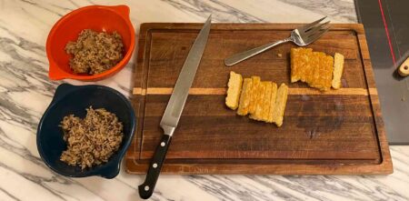 fried tempeh sliced on a cutting board